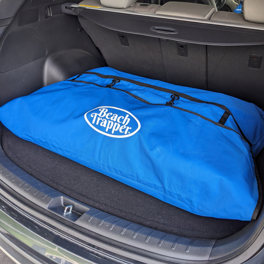A blue bag neatly placed in the trunk of a car, serving as an organizer for the car's back trunk.