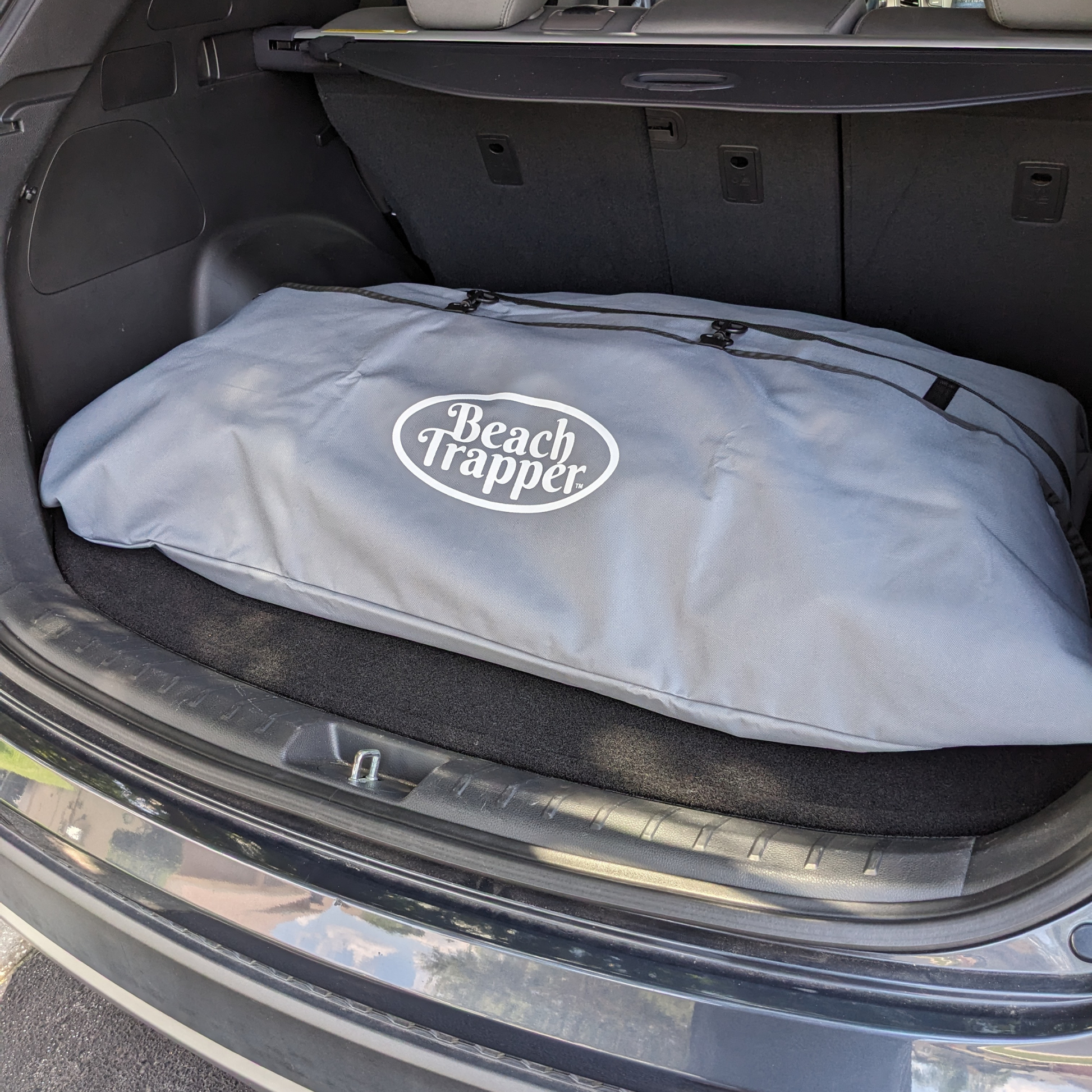 Car trunk bag for beach essentials, perfect for a day at the beach.