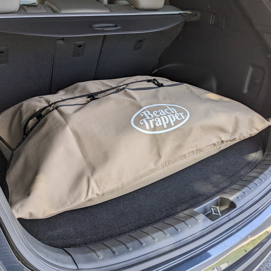 A car trunk bag with the logo of Beach Trapper car tan store imprinted on it.